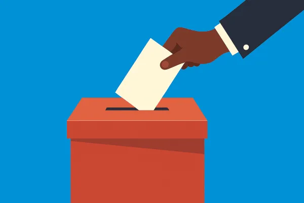 A person placing a ballot into a ballot box